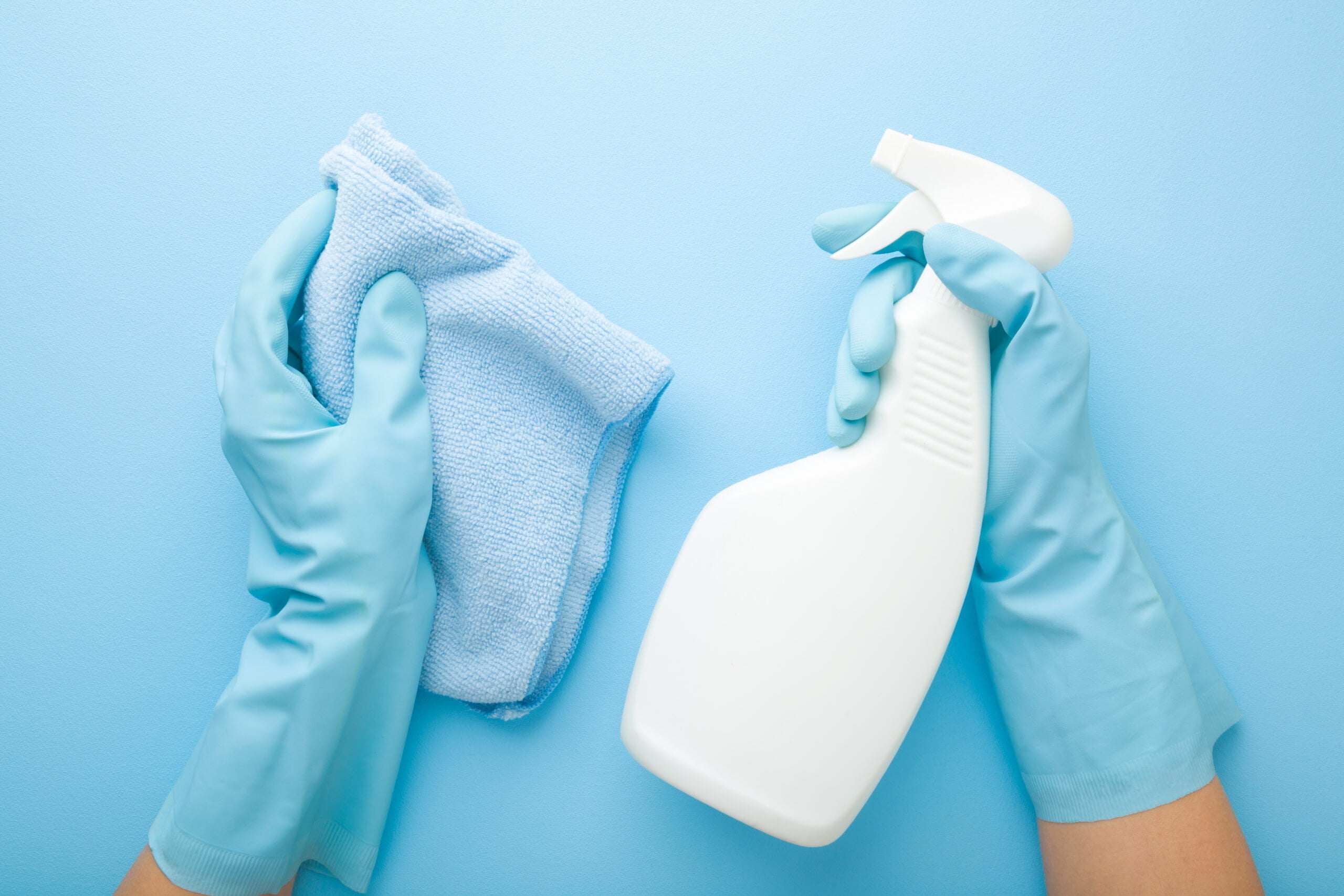 Hands,In,Rubber,Protective,Gloves,Holding,White,Spray,Bottle,And